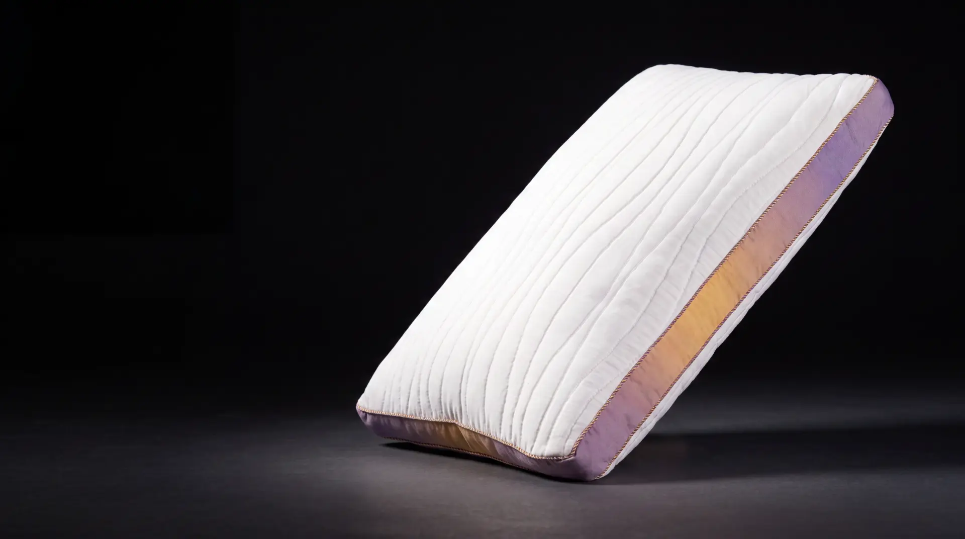 Stigma Sleep adjustable pillow tilted on a dark studio stage